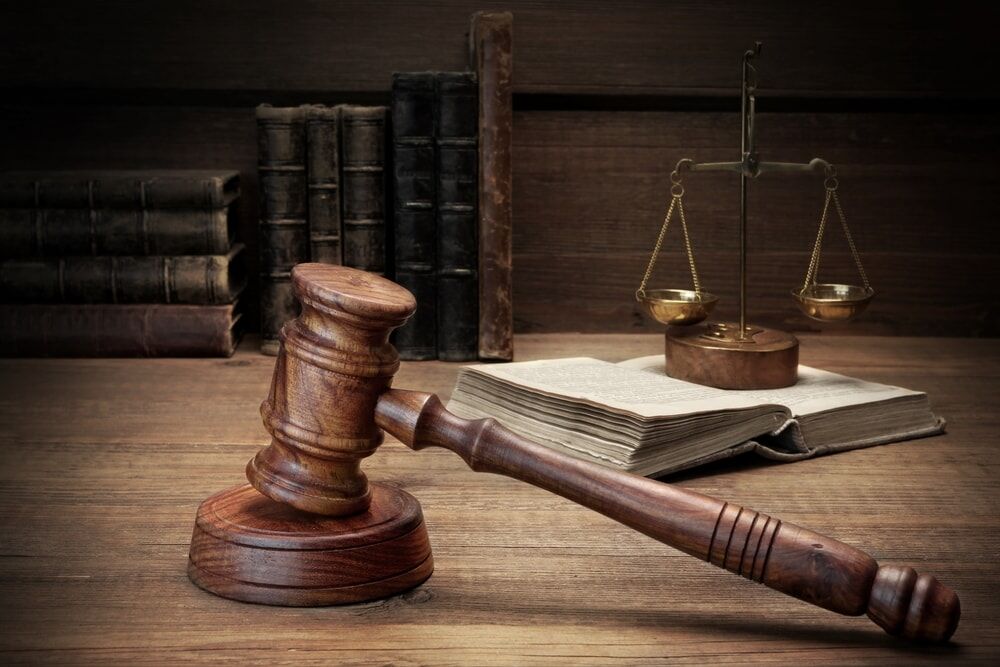 gavel pounded on block with justice scale on the side